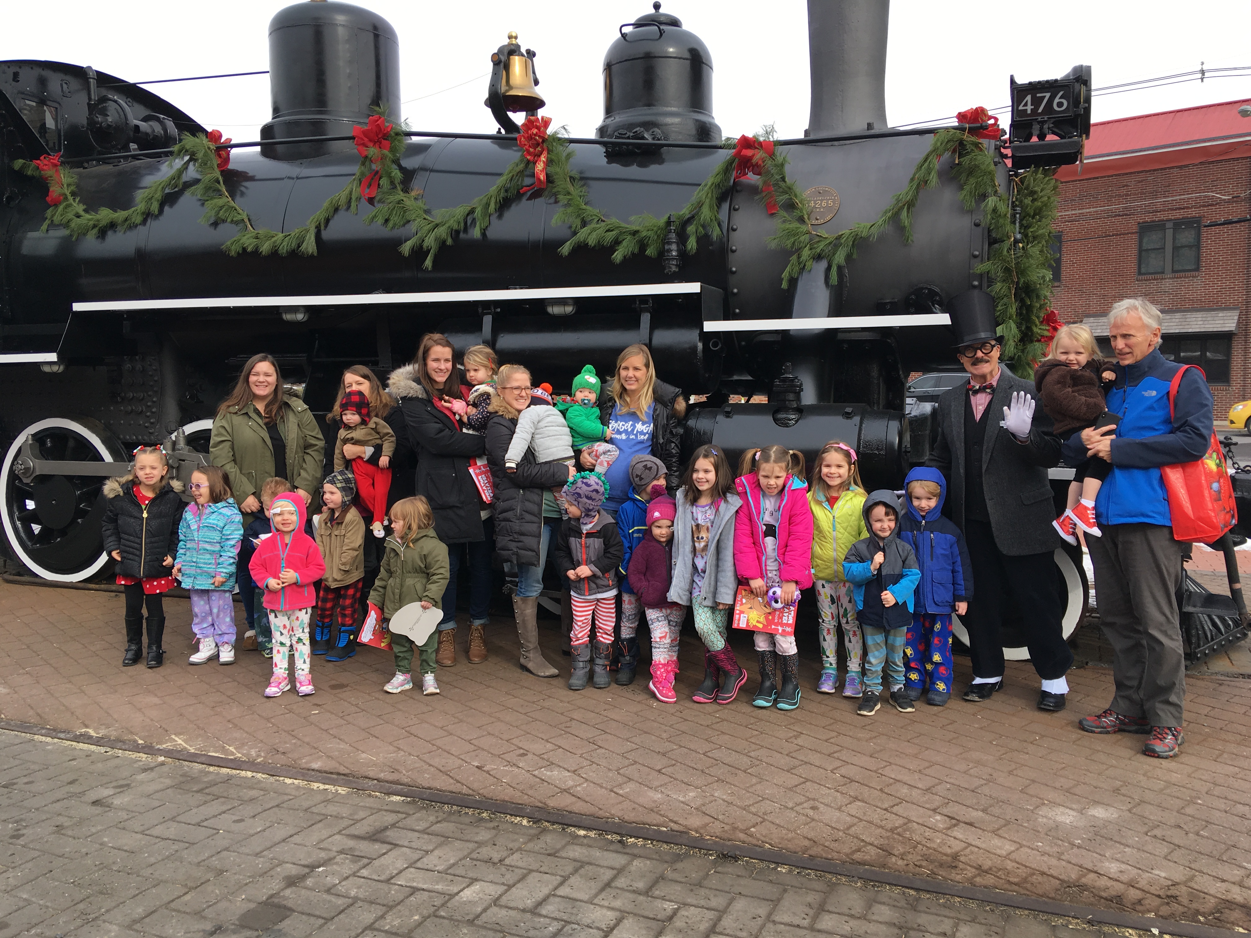 Story Time group standing in front of train