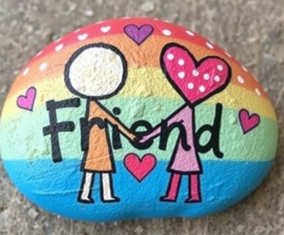 rainbow rock with word Friend on it and two stick people