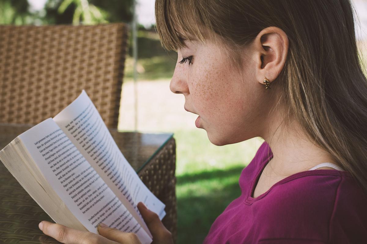 Young teen reading book